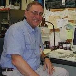 Man with graying hair and glasses