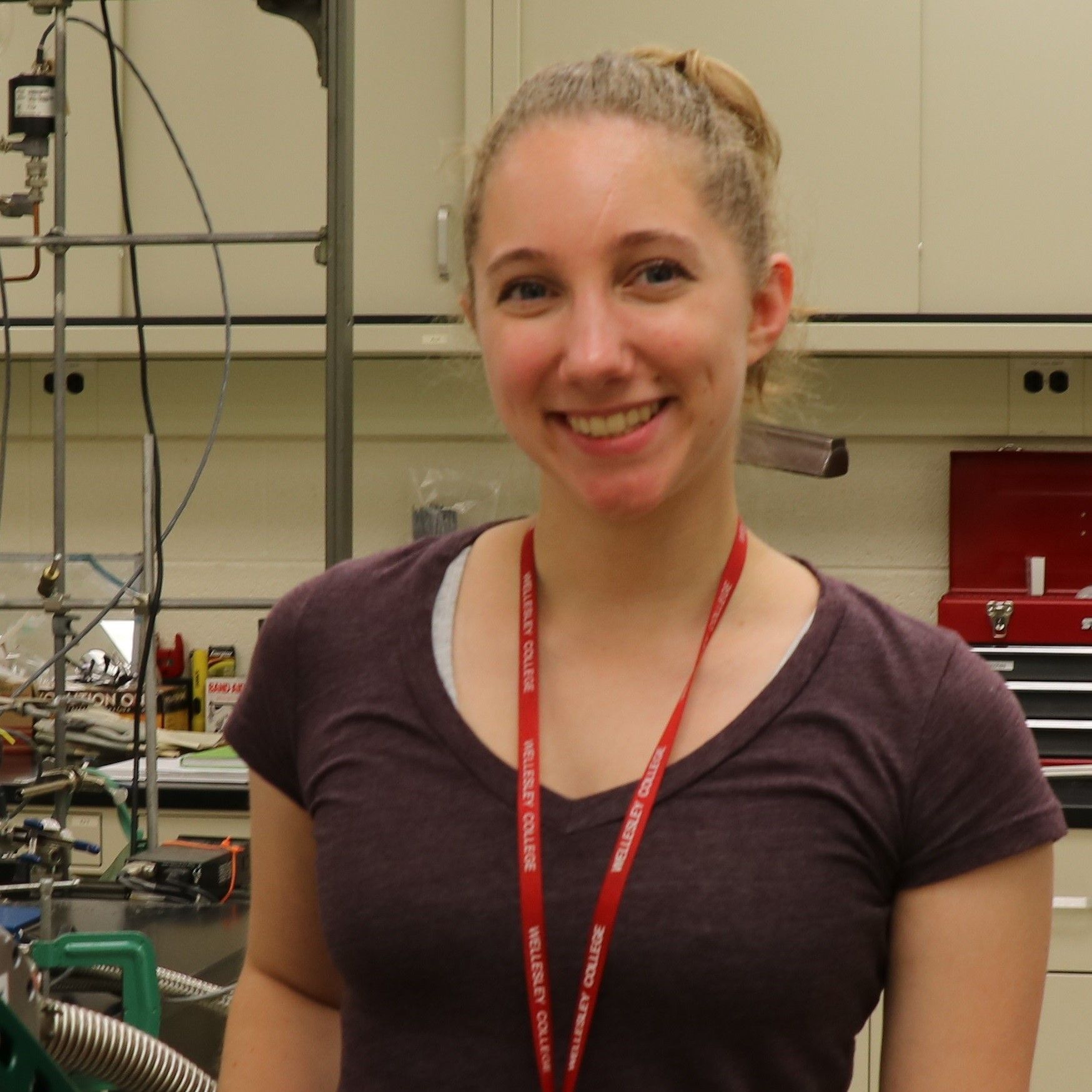 Woman with light hair pulled up into a bun/ponytail